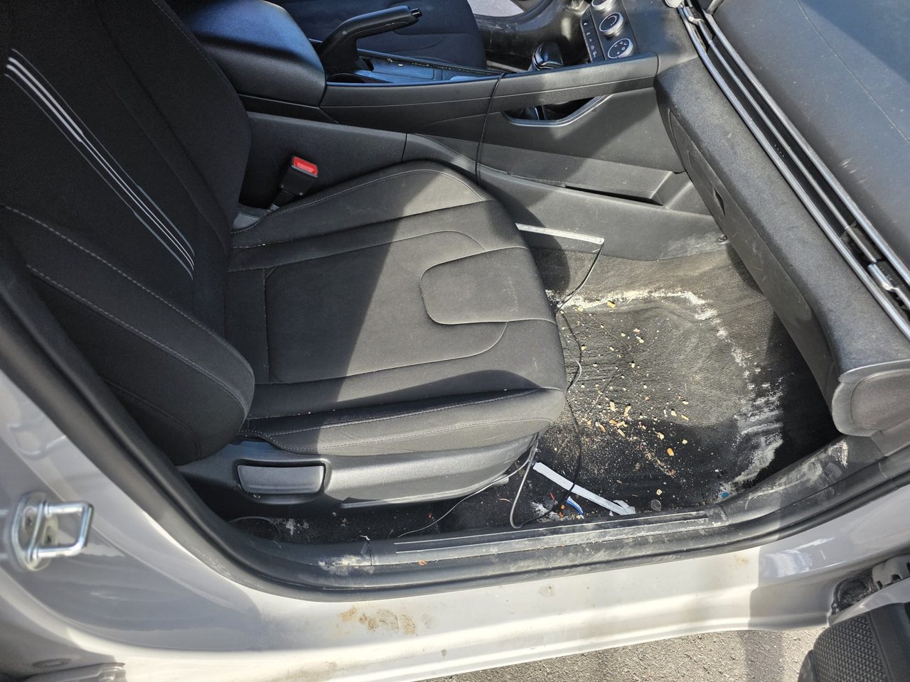 Salt-stained front passenger footwell before detailing